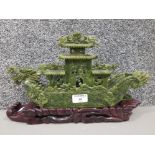 A 20th century Chinese carved soapstone boat raised on carved wooden plinth 40cm long.