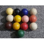 Thirteen antique billiard/snooker balls 5cm diameter.