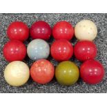 Twelve Edwardian ivory billiard/snooker balls, two natural and the others dyed red green and blue,