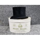 A 1920s brushed silk top hat by Henry Heath, 18.8 x 16.2cm (internal measurement) with original