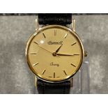 Gents 9ct gold Ingersoll watch. Featuring champagne dial with gold batons and black leather strap.