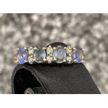 Ladies 9ct gold blue stone and Diamond ring. Featuring 4 oval blue stones and Diamonds in between.
