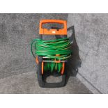 A garden hose on push along stand.