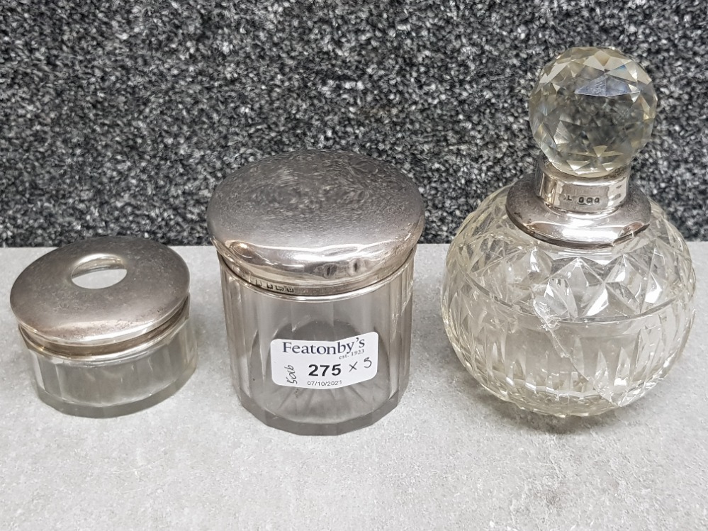 Two handcut glass silver topped dressing table jars one of which is a hair receiver, rubbed marks