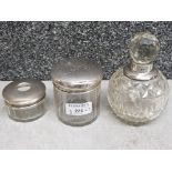 Two handcut glass silver topped dressing table jars one of which is a hair receiver, rubbed marks