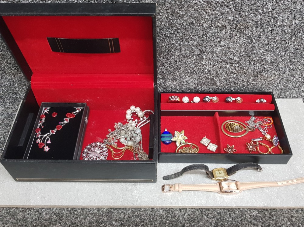 Costume jewellery to include rings, earrings, cocktail watches, in a black jewellery box.