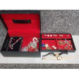 Costume jewellery to include rings, earrings, cocktail watches, in a black jewellery box.