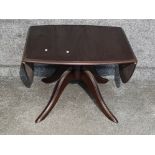 Stag drop leaf coffee table on pedestal base