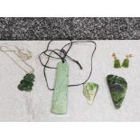 Jade jewellery comprising two pendants and a pair of earrings together with two rocks.