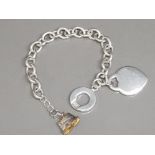 Silver bracelet with 925 padlock shaped charm and circle charm, plus gold & silver shorts charm,
