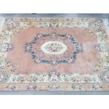 A Chinese wool rug with floral decoration on pink ground 260 x 184cm.