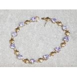 9ct yellow gold Heart & clover bracelet set with 11 purple stones, length 19.5cm, 8.4g gross