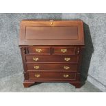 A Georgian style hardwood bureau opening to reveal fitted interior with drawers below 76 x 88 x