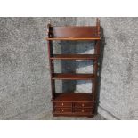 A mahogany floor standing display unit with four small drawers 50 x 109 x 16cm.