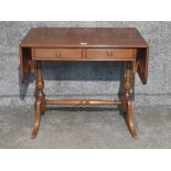 A reproduction mahogany sofa table 142cm wide fully extended.