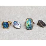 A silver and paua ring size L 1/2 and earrings, together with another paua ring.