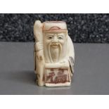 Hand carved bone netsuke, carved as an elder with staff