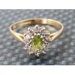 Ladies 9ct yellow gold peridot & cubic zirconia cluster ring comprising of a oval peridot set in the