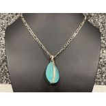 Ladies Silver Figaro chain with blue pear shaped stone pendant