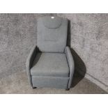 A grey armchair with fold down back.
