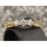 Ladies 9ct gold diamond ring. Comprising of 3 round brilliant cut diamonds and 3 diamonds on each