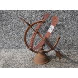 A metal armillary sphere 32cm high.