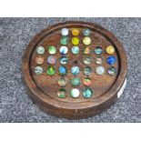 Oak solitaire board with marbles