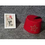 A Tommy Cooper signed picture with associated fez.