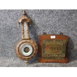 An oak and brass wall mounted papers rack and a barometer (SAS).