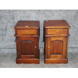 A pair of stained wood bedside cupboards.