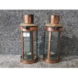 A pair of copper and glass lanterns 29cm high.