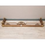 A brass extending fire curb 140cm wide (smallest setting).