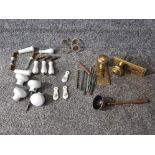 Brass and ceramic door handles, three escutcheons etc.