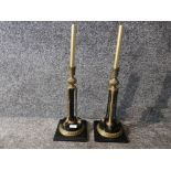 A pair of black veined polished slate and ormolu empire style candlesticks 39cm high.