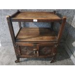 A stained oak trolley with cupboard below.