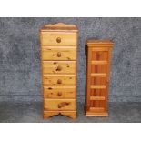 A pine chest of narrow drawers 43.5 x 114 x 41cm and a CD cupboard.