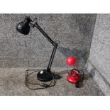 A black anglepoise lamp and a smaller red lamp.