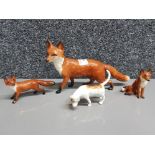 Three Beswick foxes and a hound.