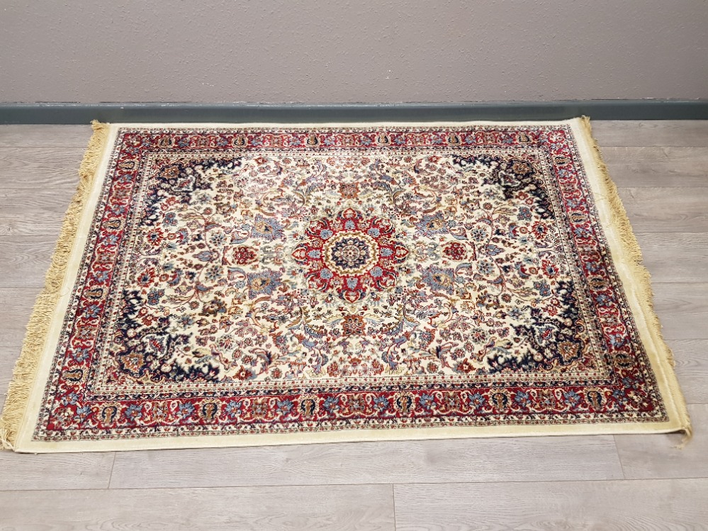 A Persian wool rug with floral motifs on cream ground 170 x 116cm