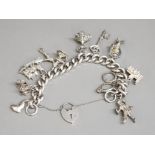 Silver charm bracelet with silver padlock & 11 charms, 75.3g gross