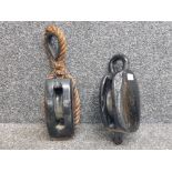 Two black painted wooden ship's pulleys.