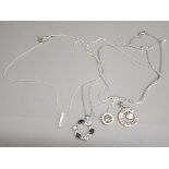 Four silver plated pendants & chains