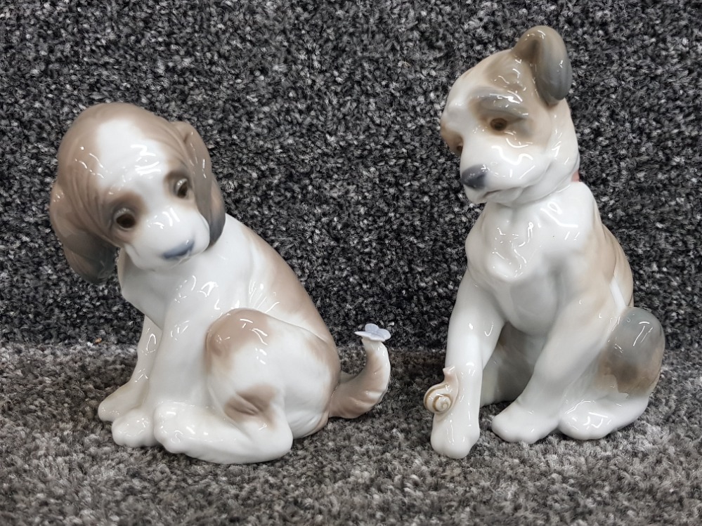 Two Lladro puppies with butterfly and snail no 6210 and 6211.
