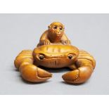 Finely carved hardwood netsuke depicting monkey on crabs back