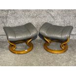 Pair of Grey leather foot stools with wooden base.