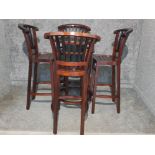 A stained wooden bar table and four matching stools.
