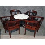 A circular marble top bar table and four chairs.