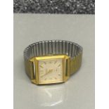 A gents Ingersoll square faced gold coloured wristwatch.