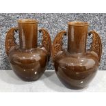 Pair of brown ceramic vases with decorative handles