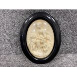 Late Victorian to early 1900s carved relief of Madonna and child in ebonised oval frame